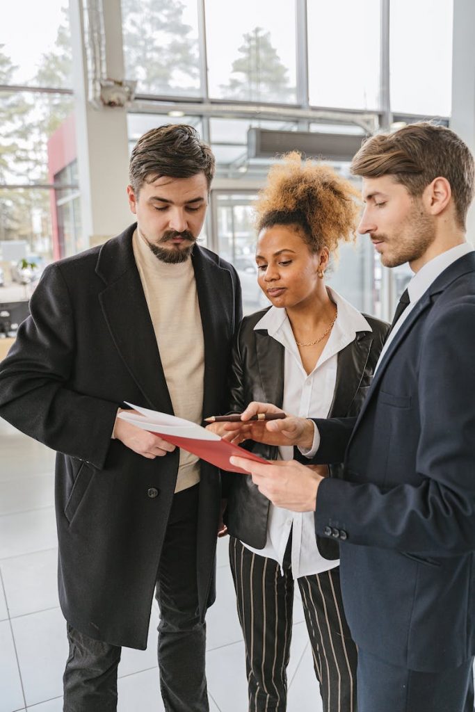 Photo of a Couple Talking to a Salesman